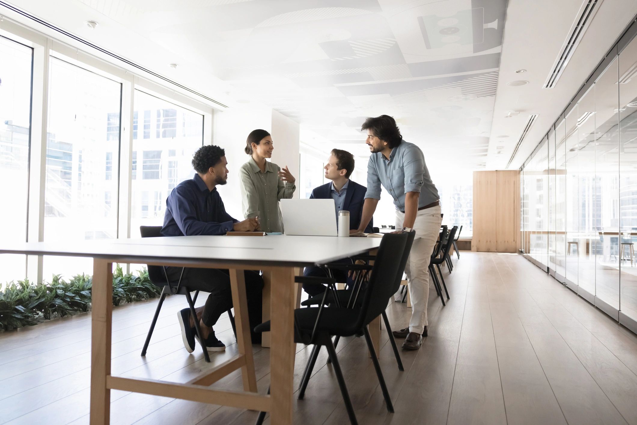 Team collaboration around a laptop during a strategy meeting